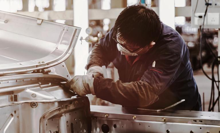man working on car body
