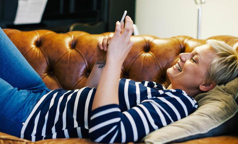 Woman using mobile app to communicate with neighbors