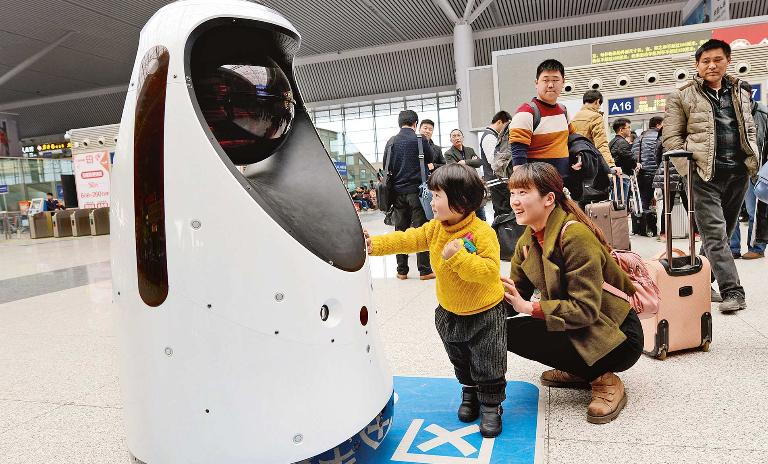 To protect and serve: The police robot at Zhengzhou East Railway Station can clean, monitor air quality, detect fire and also compare passenger faces to those of escaped criminals.